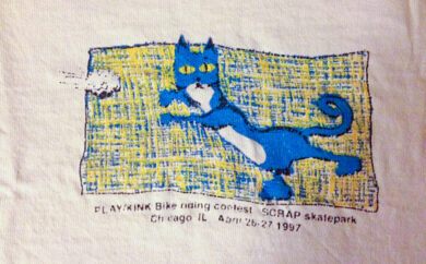 Scamper catching a paperball on a PLAY/Kink contest tee